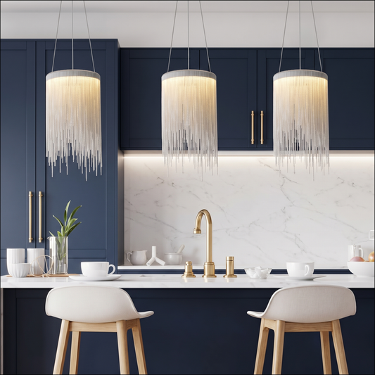Three pendant lights above a white kitchen island with marble countertop